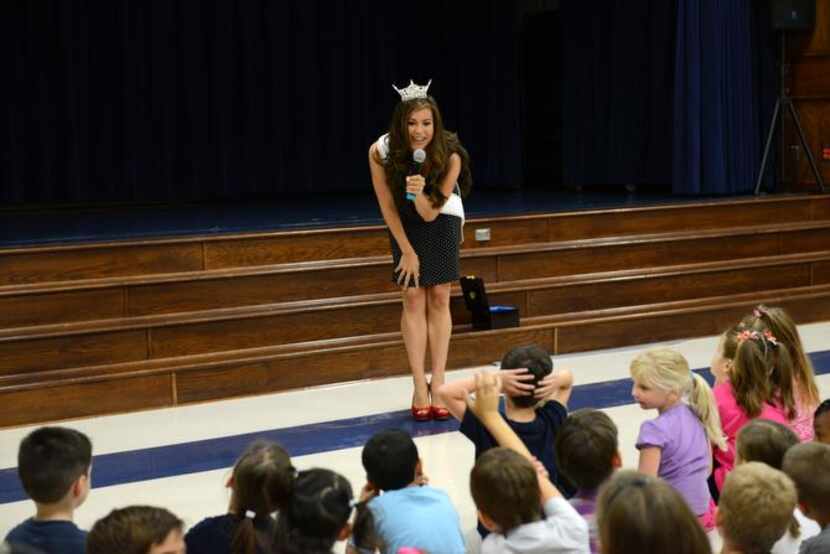 
Monique Evans talks to students at an assembly. On being a role model, the pageant...