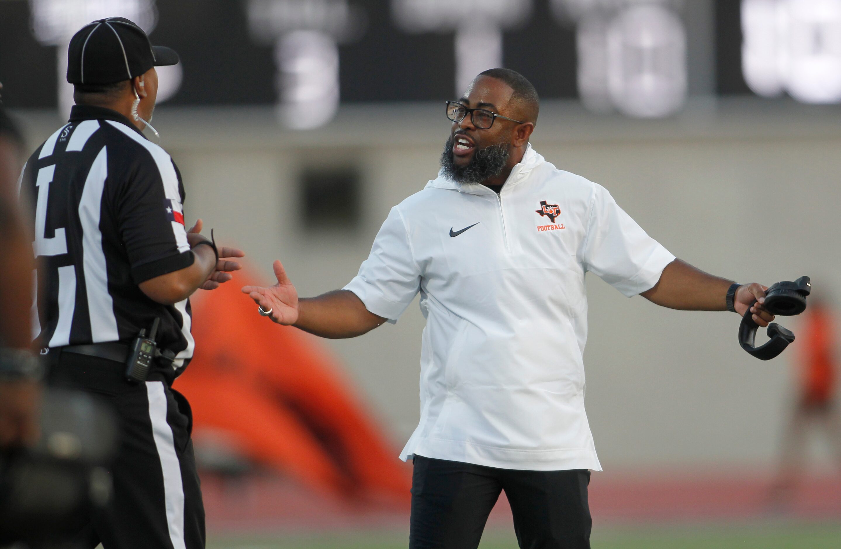 Lancaster head coach Leon Paul questions the call of a game official during first half...