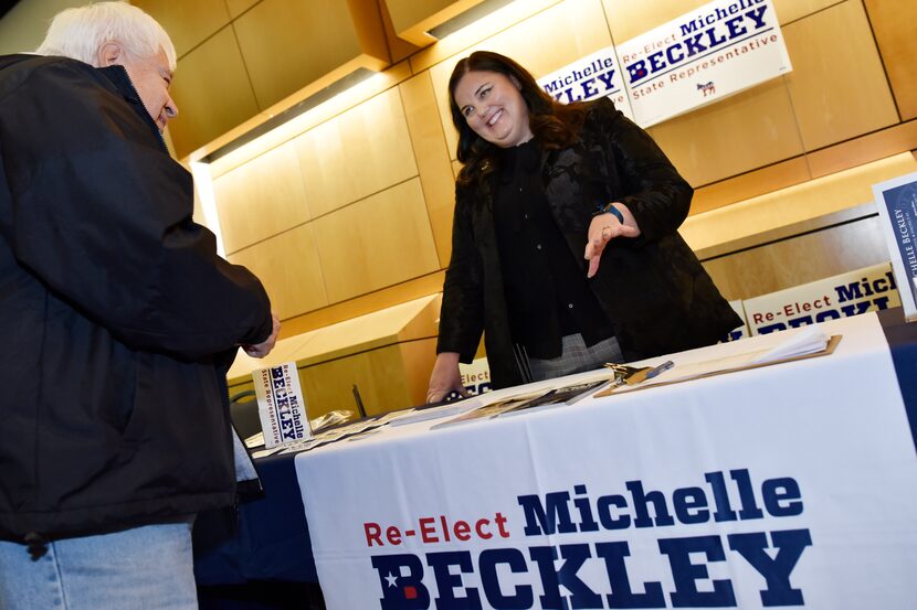 Incumbent Michelle Beckley, right, meets with voter Eddie Reyes, left, of Carrollton, before...