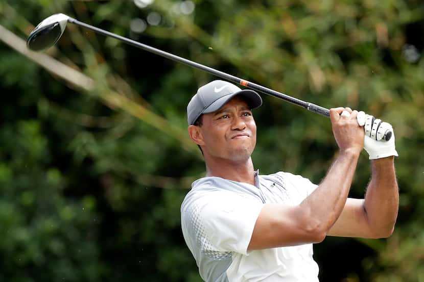 Tiger Woods hits a shot from the 11th tee during the third round of the The Players...