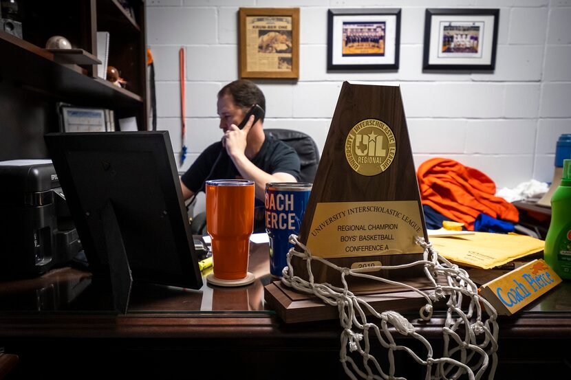 The team's 2019 UIL Regional Championship trophy sit on his desk as Slidell High School head...