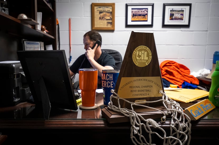 The team's 2019 UIL Regional Championship trophy sit on his desk as Slidell High School head...
