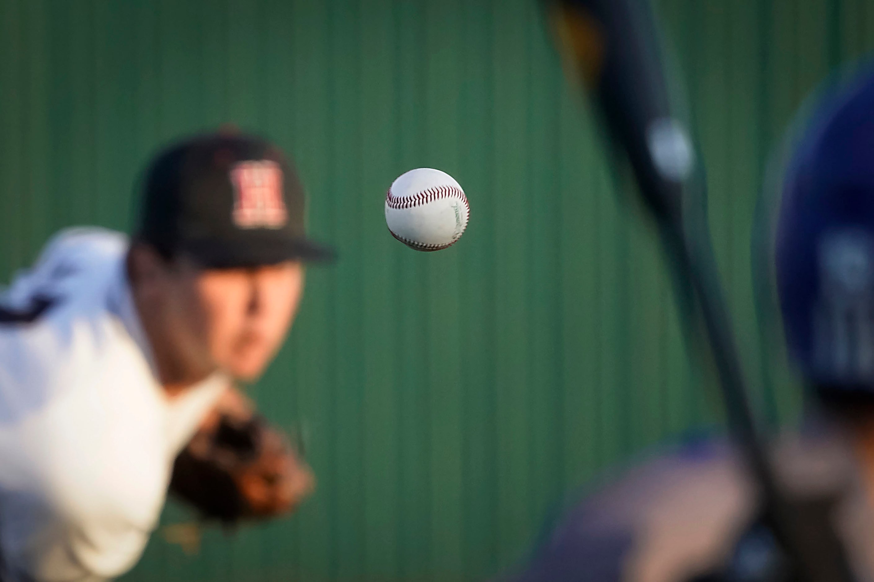 Rockwall-Heath pitcher Josh Hoover delivers to North Mesquite pitcher Kolby Long during a...