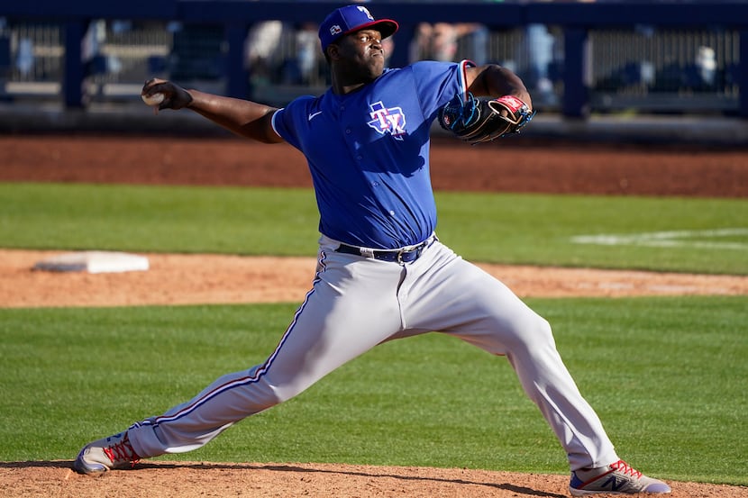 Texas Rangers pitcher Demarcus Evans pitches during the ninth inning of a spring training...
