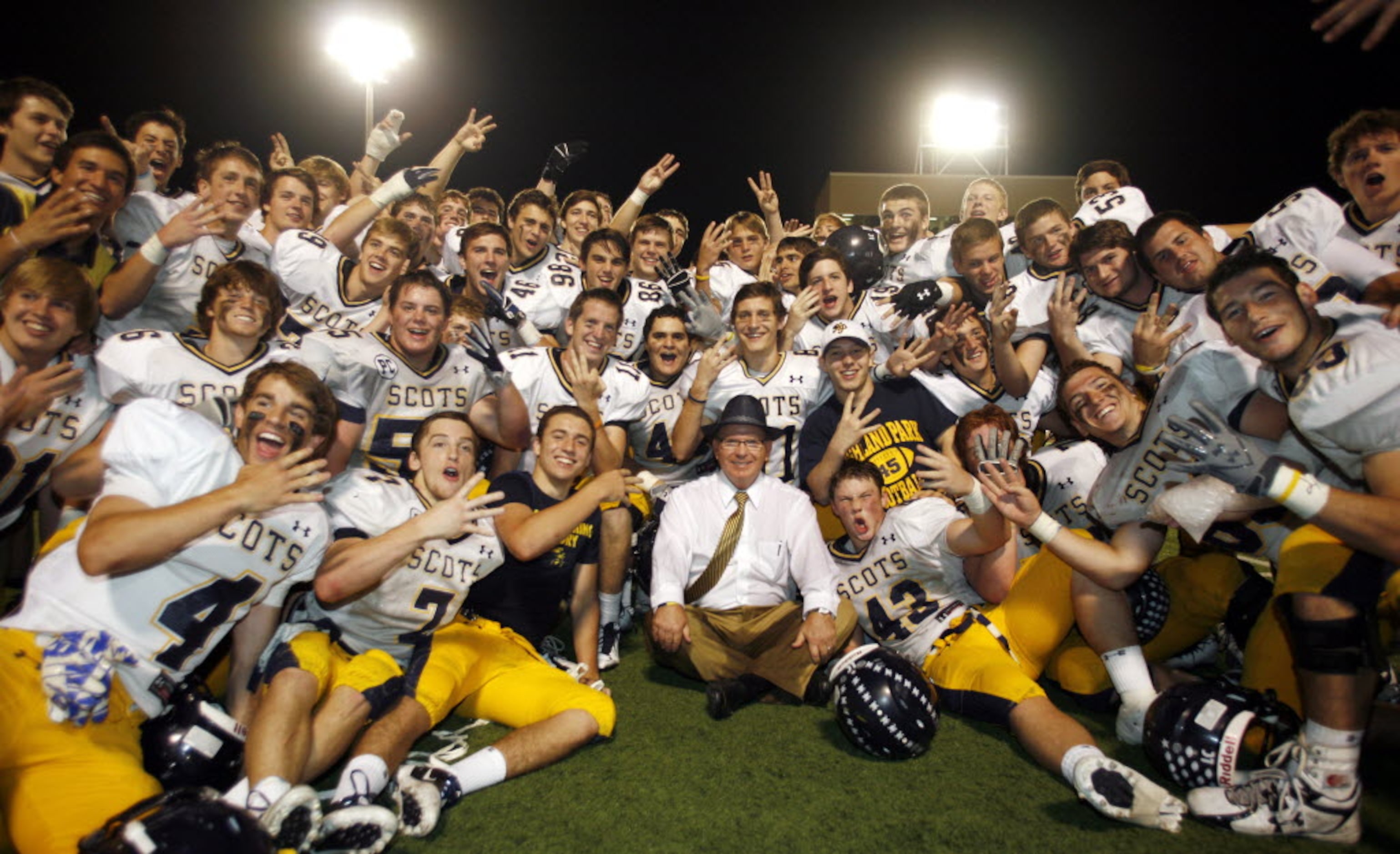 Highland Park Head Coach Randy Allen (center) celebrates his 300th career victory with the...