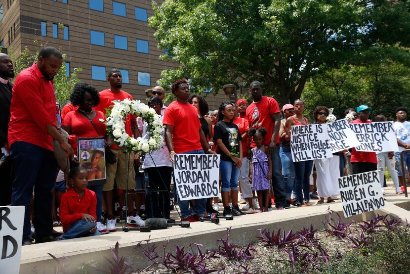 A crowd gathers, from left, including Lee Merritt, Charmaine Edwards, Odell Edwards on the...