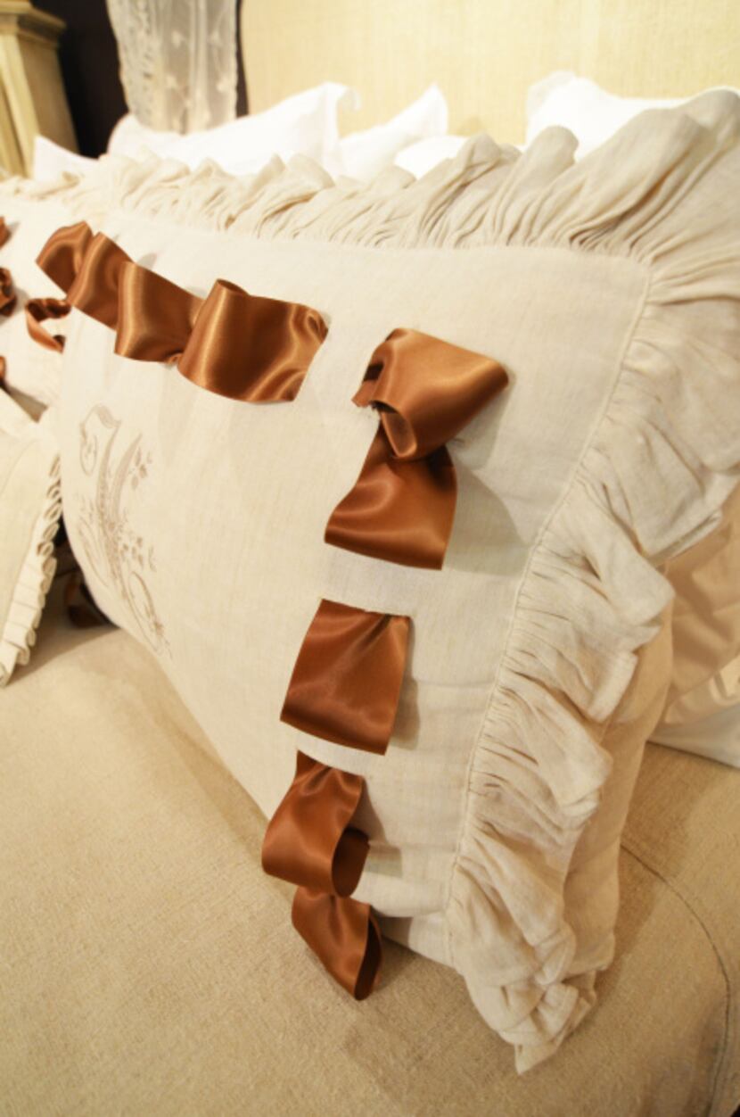 De Balthazar weaves in a simple silk ribbon to change the look of this antique linen pillow...