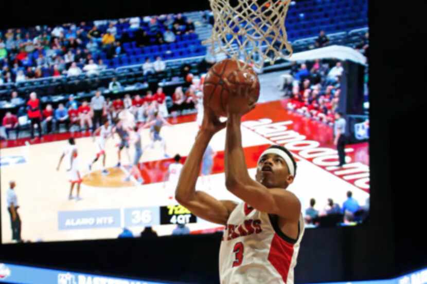 Justin Northwest's Avery Anderson scores a basket during a Class 5A state semifinal against...