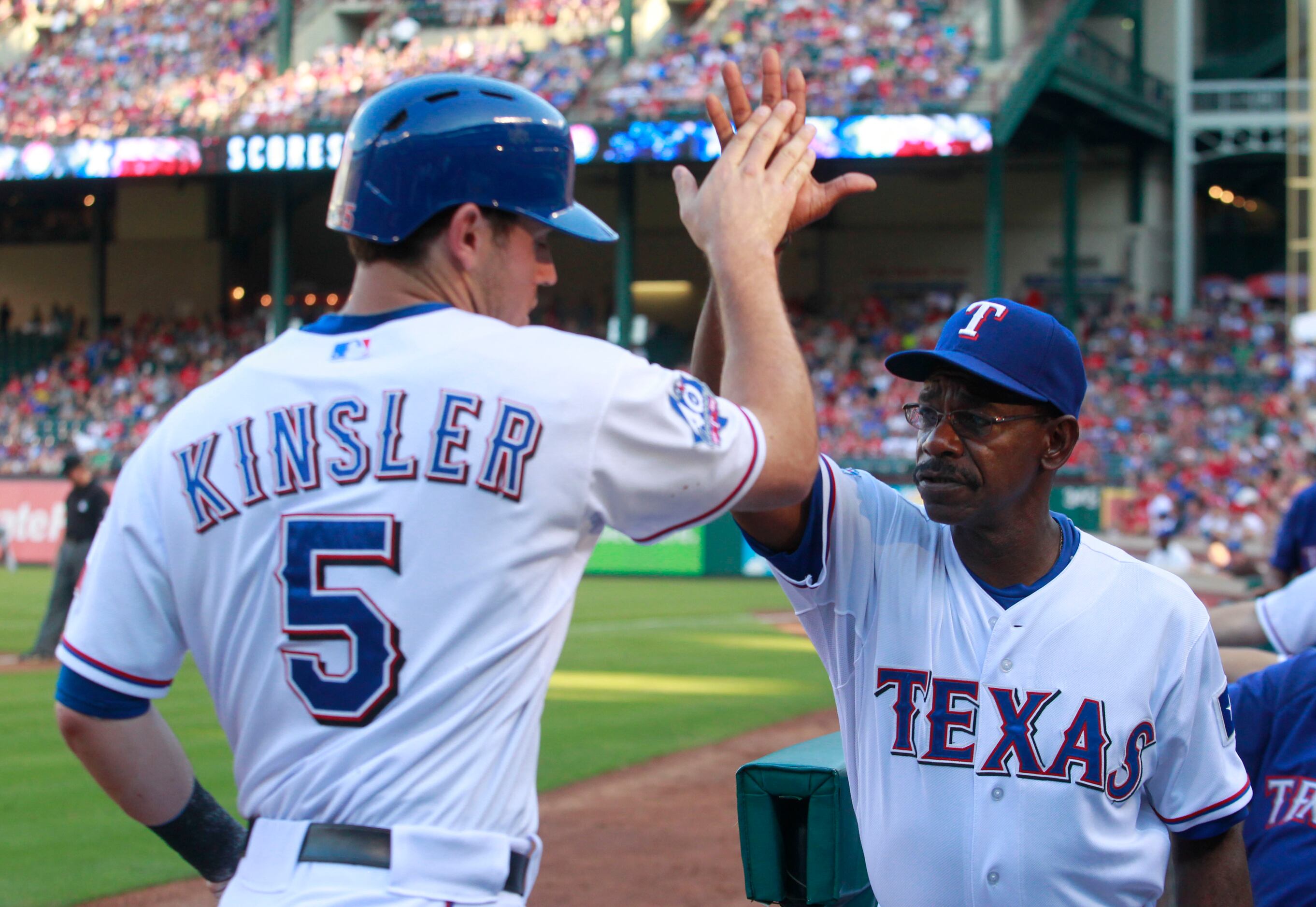 Texas Rangers' Ian Kinsler, right, walks off the field with Rangers manager  Ron Washington, left, after Kinsler's two home runs led the Rangers to a  5-1 win over the Seattle Mariners in