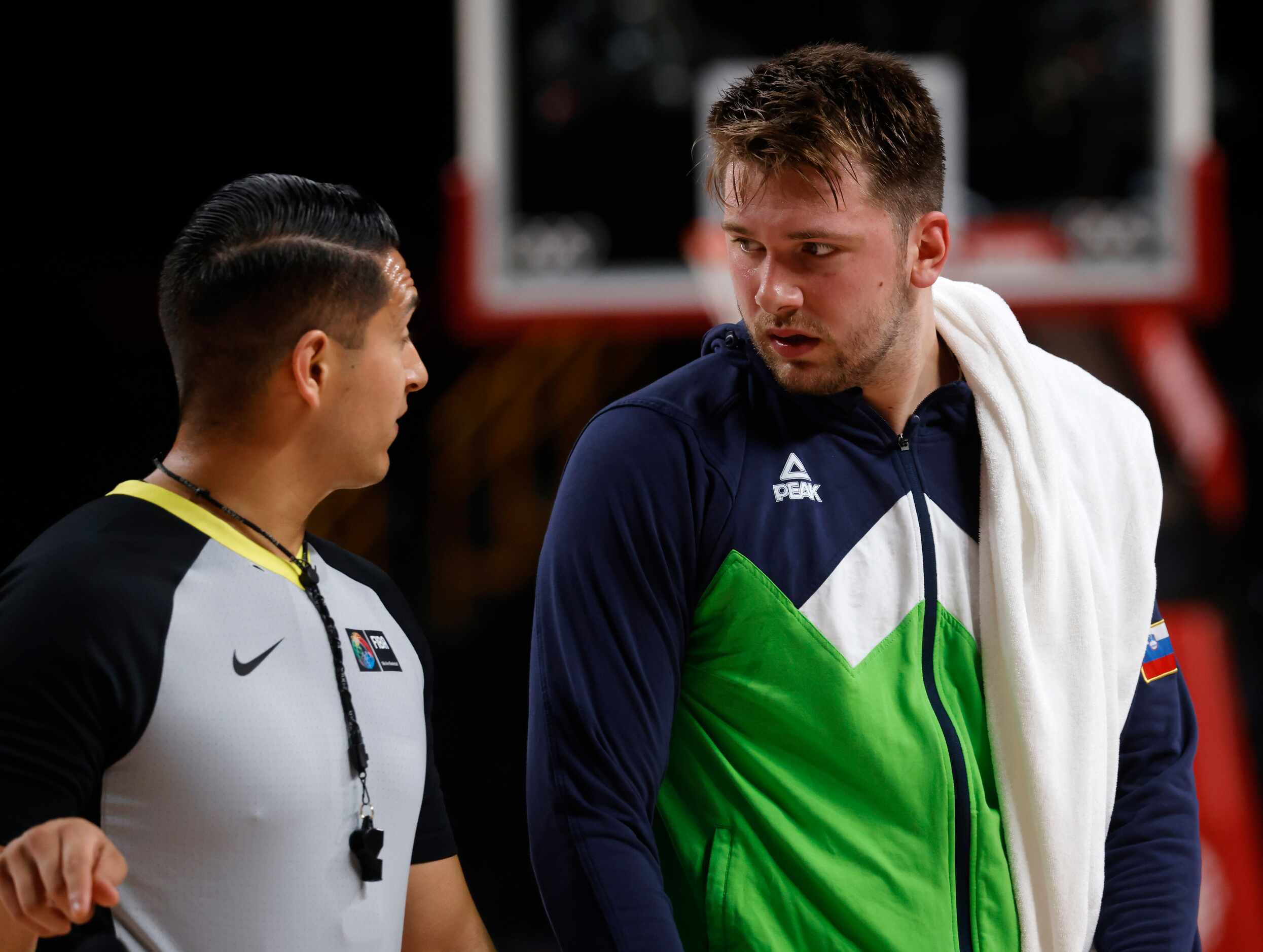 Slovenia’s Luka Doncic (77) talks to an official as they play Germany during the first half...