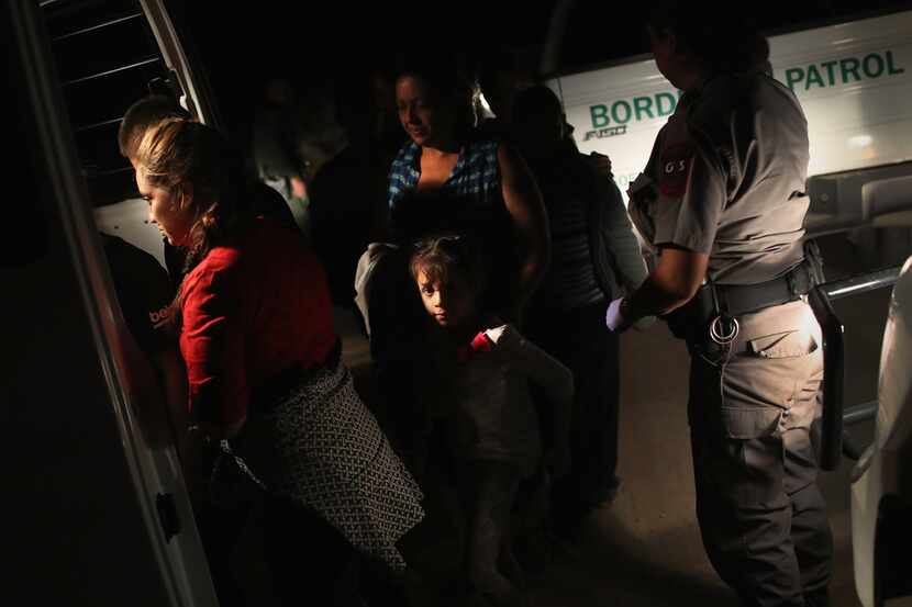 U.S. Border Patrol agents detain a group of Central American asylum seekers near the...