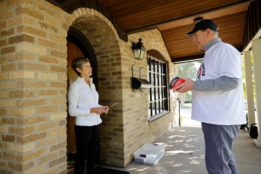 Former Dallas Mayor Mike Rawlings talks with Margaret Preston, a resident along Vanderbilt...