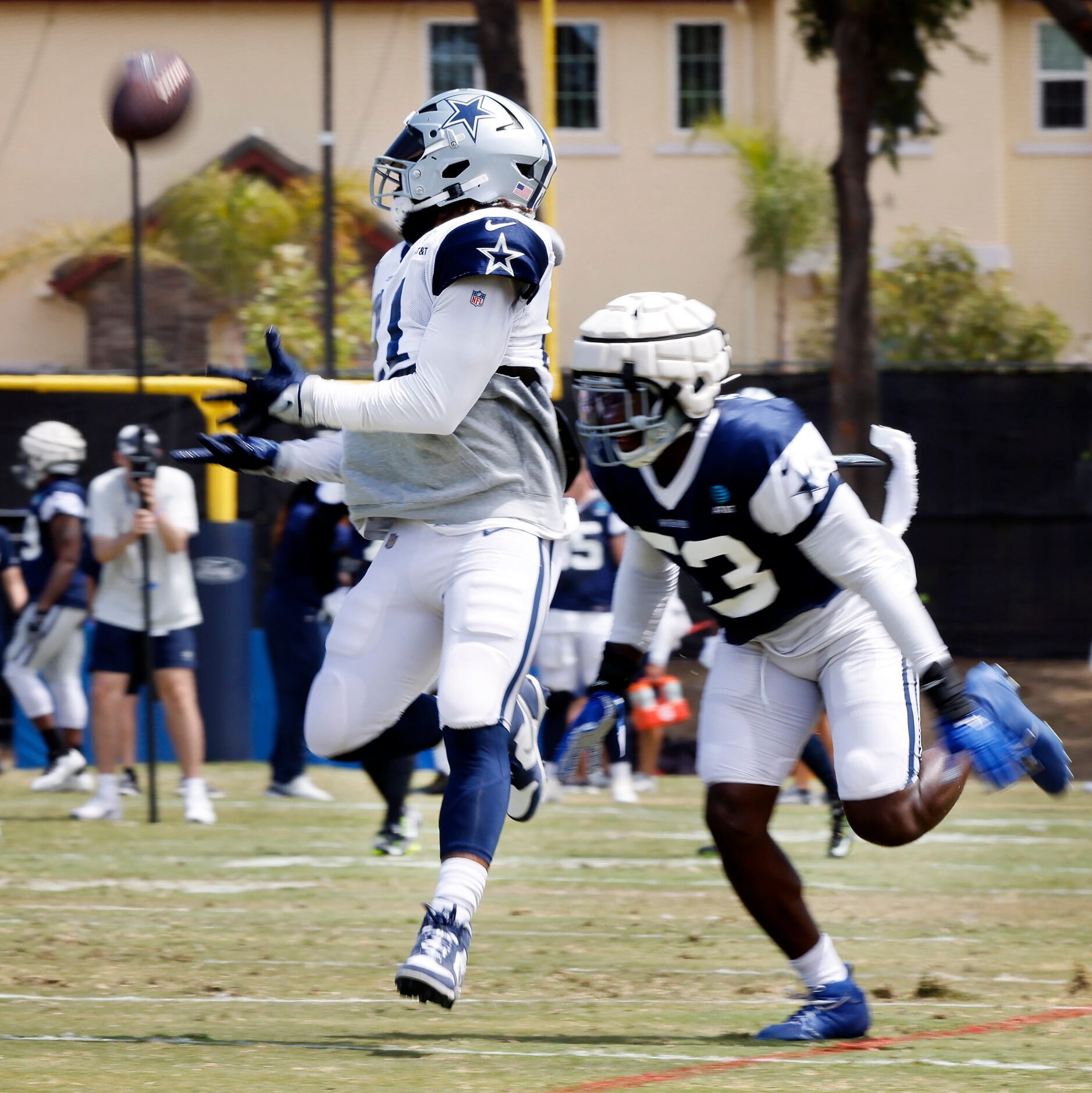 Dallas Cowboys running back Ezekiel Elliott (21) looks back for and completes a deep pass as...