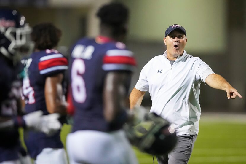 Denton Ryan head coach Dave Henigan directs his team as they take the field for overtime...