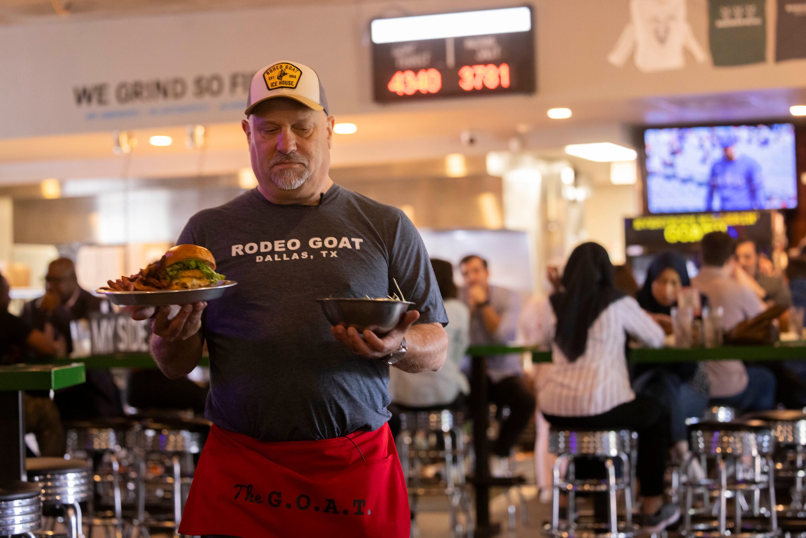 The Dallas Morning News’ Rangers reporter delivers food to a table as he "works a shift"...