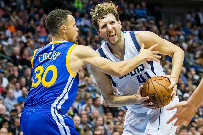 Golden State Warriors guard Stephen Curry defends against Dallas Mavericks forward Dirk...