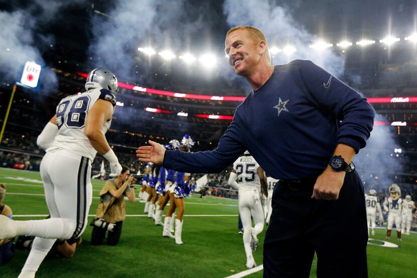 Dallas Cowboys head coach Jason Garrett greets his players during team introductions before...