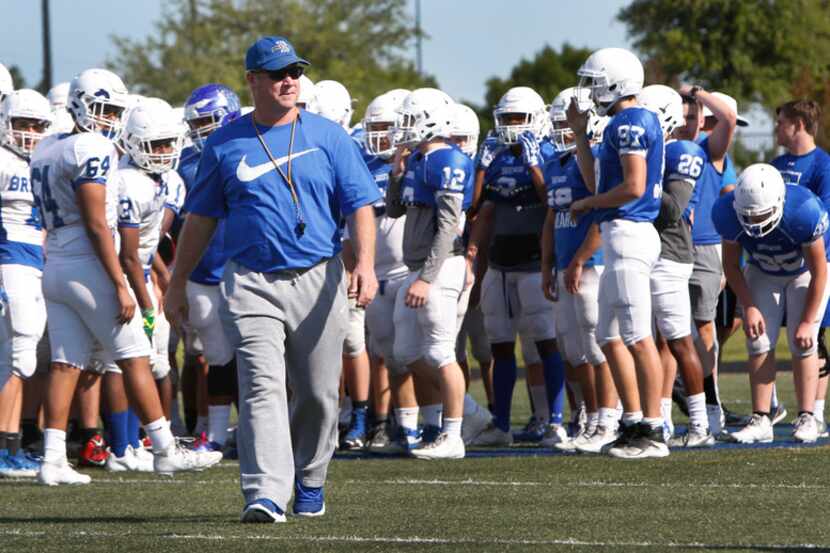 Fort Worth Brewer football coach Todd Peterman heads toward the team sidelines after giving...