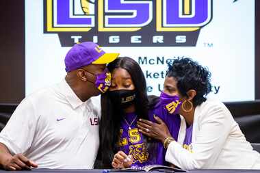 Rockwall-Heath girls basketball player Logyn McNeil is congratulated by her parents, Vincent...