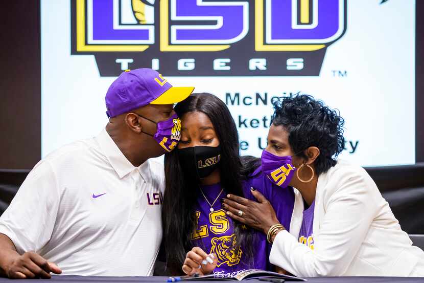 Rockwall-Heath girls basketball player Logyn McNeil is congratulated by her parents, Vincent...