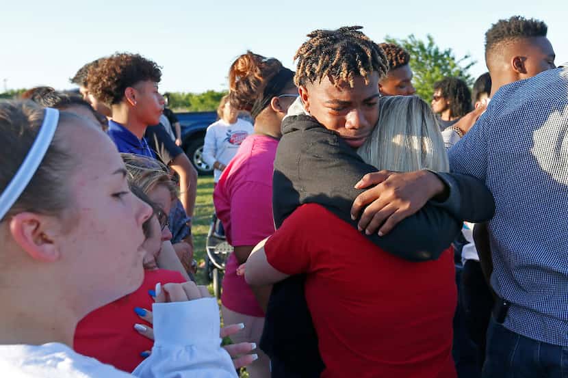 Denarius Roberts and Lani Proper console each other at a a vigil Monday for Jordan Edwards...