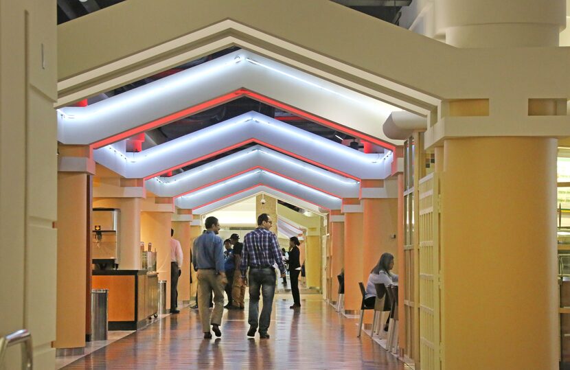 Pedestrians make their way into the food court area below the Bank of America Building in...