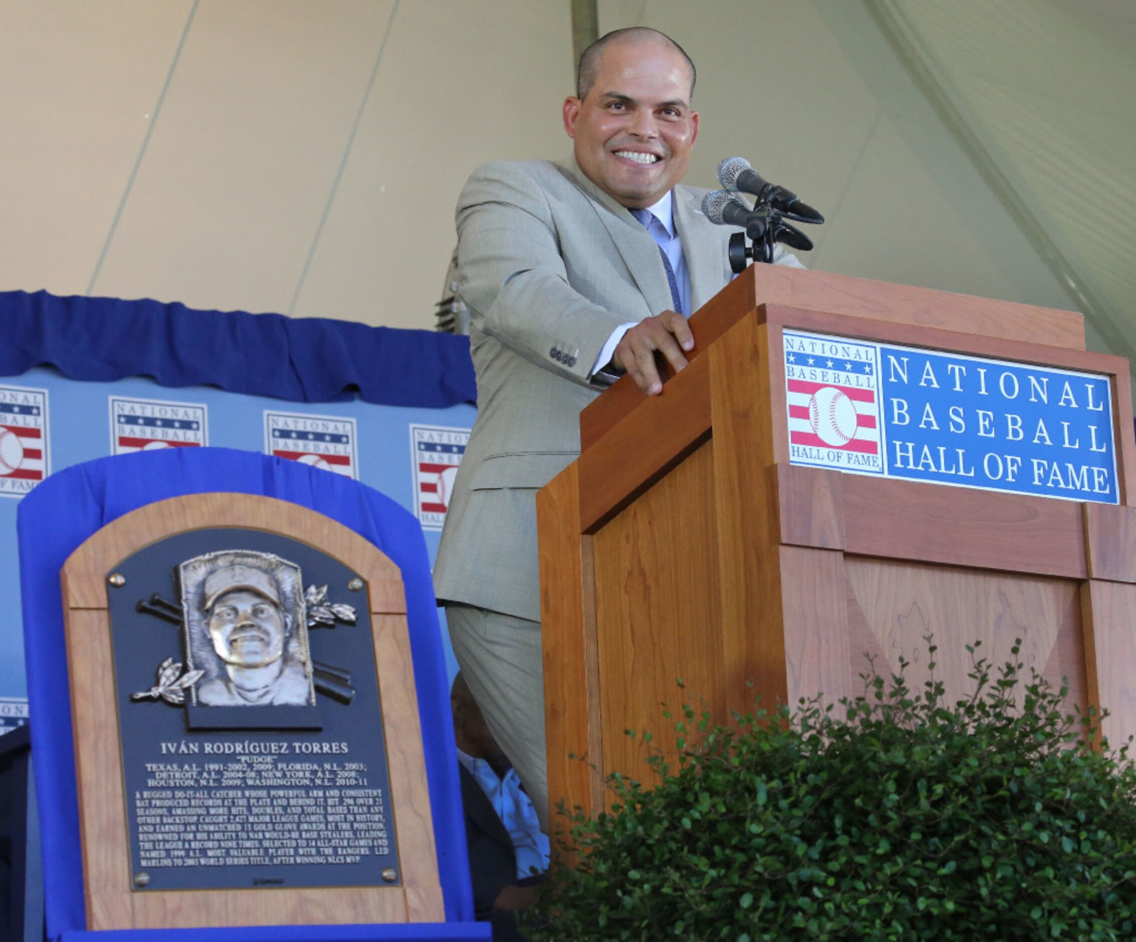 Baseball Hall of Famer Ivan Pudge Rodriguez, foreground, hugs