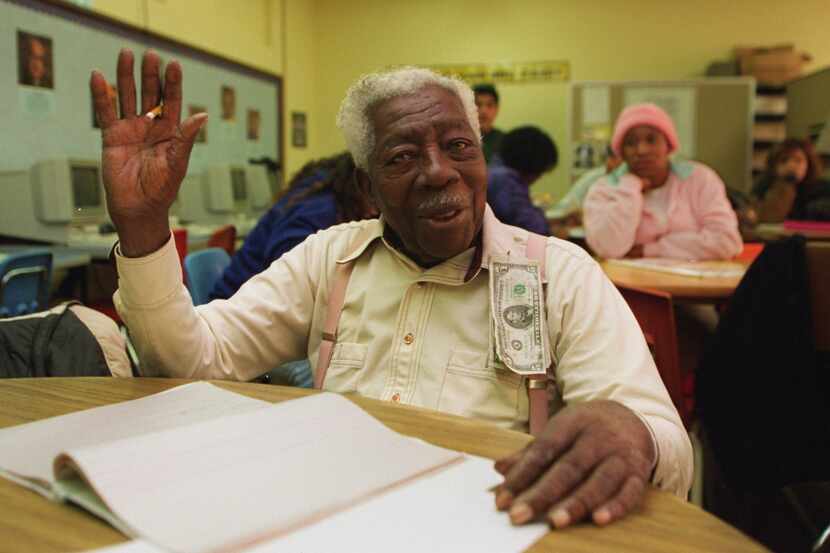 Then-98-year-old George Dawson gestures after receiving much attention during class before...