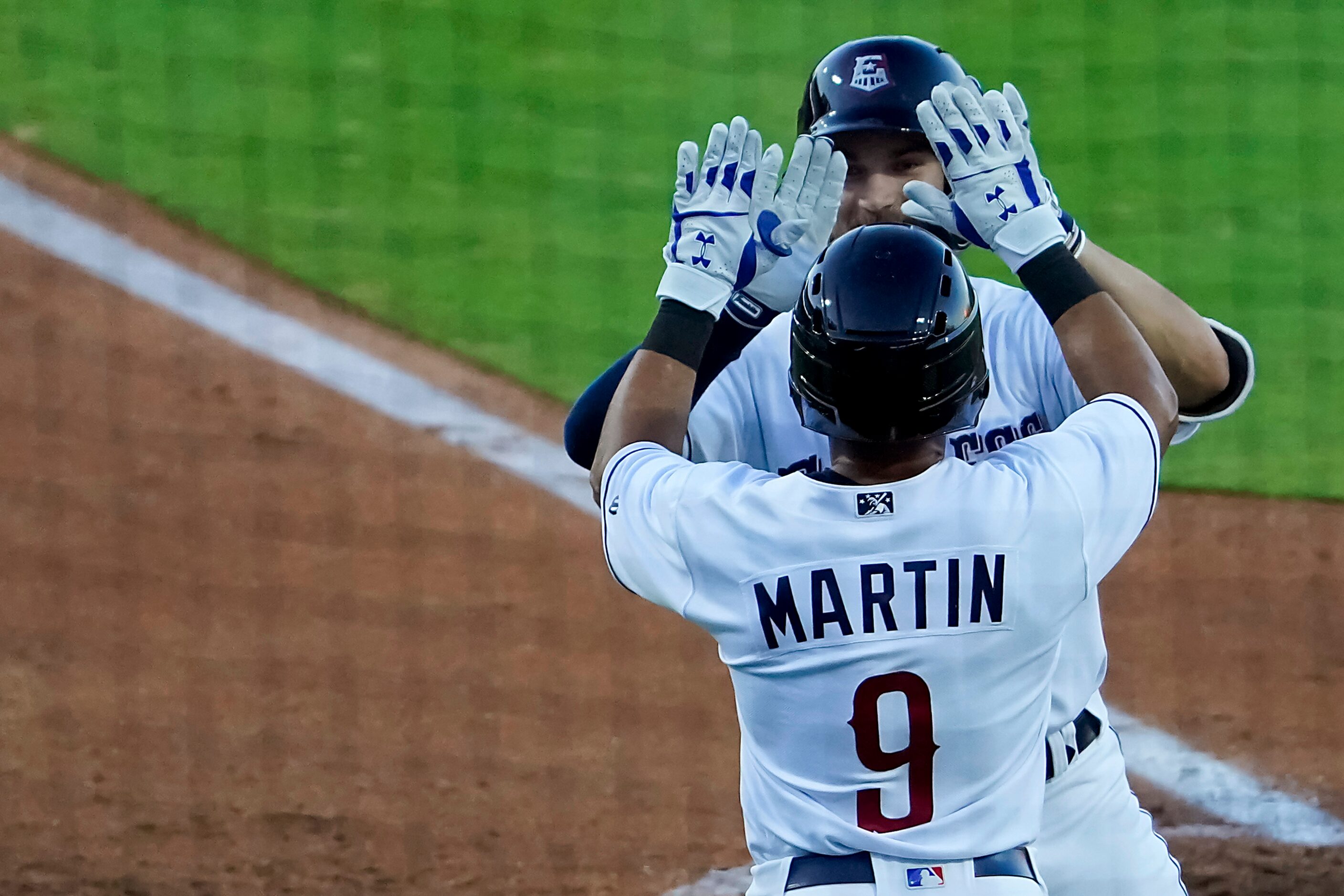 Round Rock Express infielder Charles Leblanc celebrates with outfielder Jason Martin after...