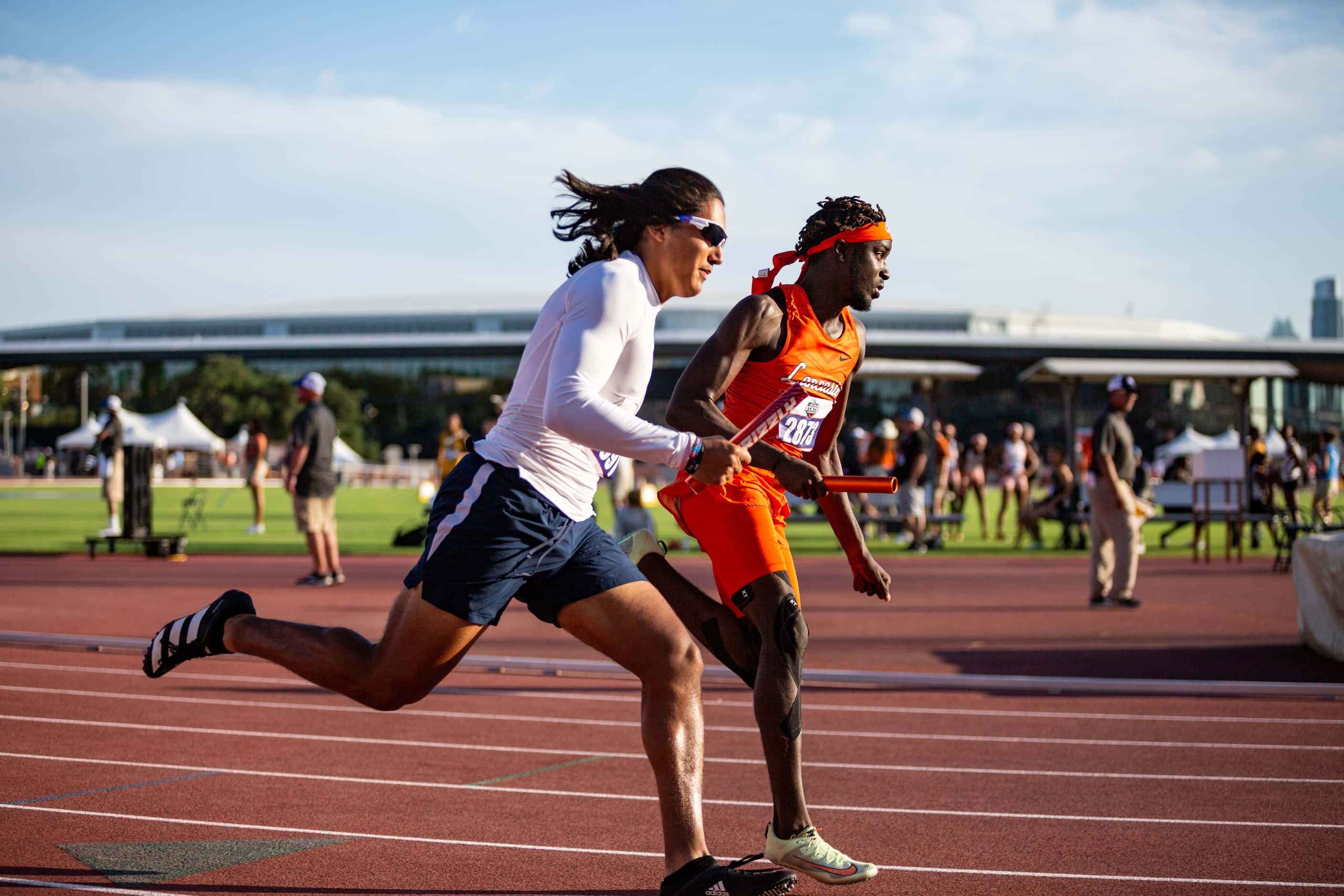 Lancaster’s Tomadric Jessie, right, competes in the boys’ 4x200 relay final at the UIL Track...