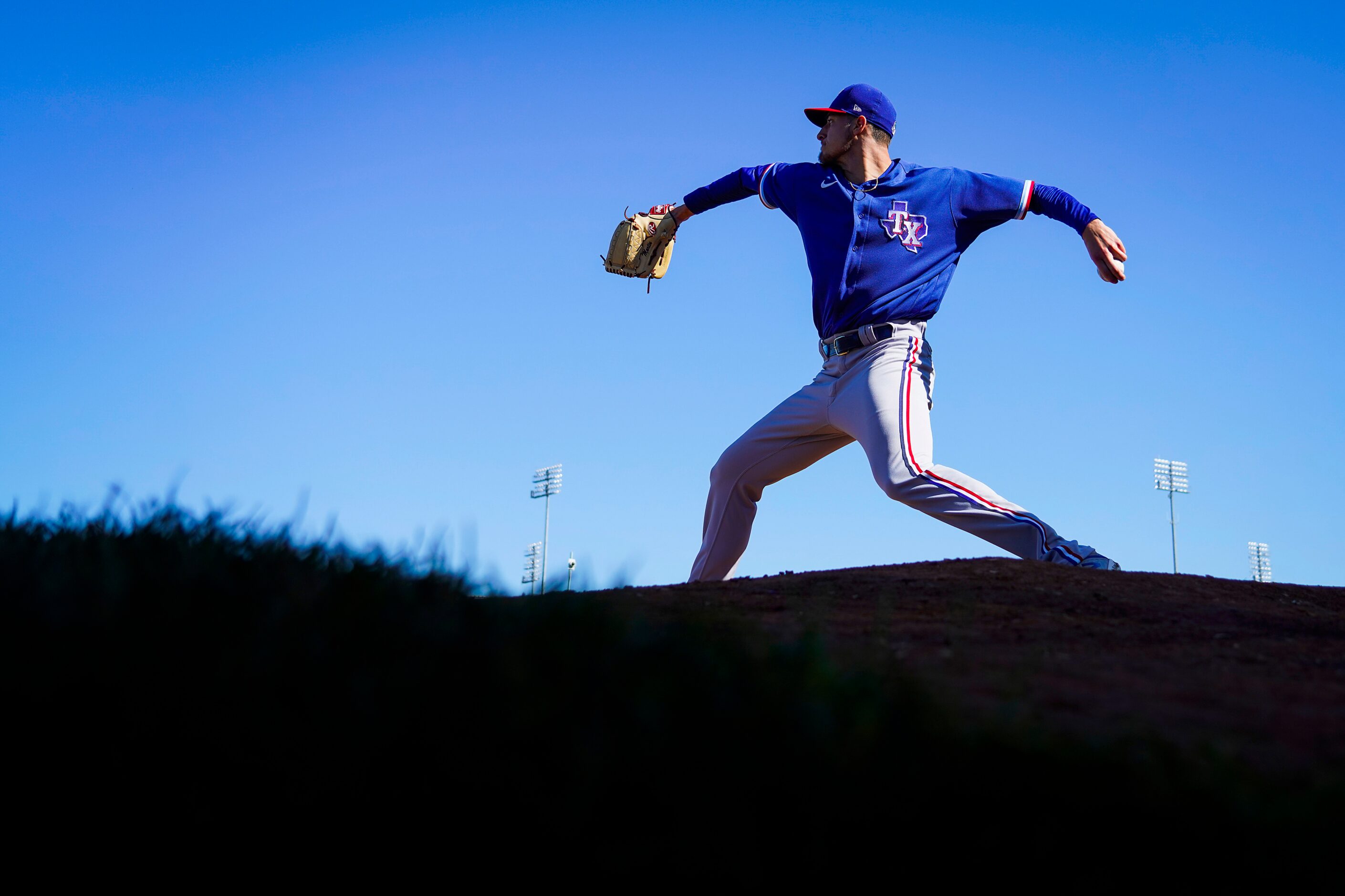 Texas Rangers pitcher Brett Martin throws in the bullpen during a training workout at the...