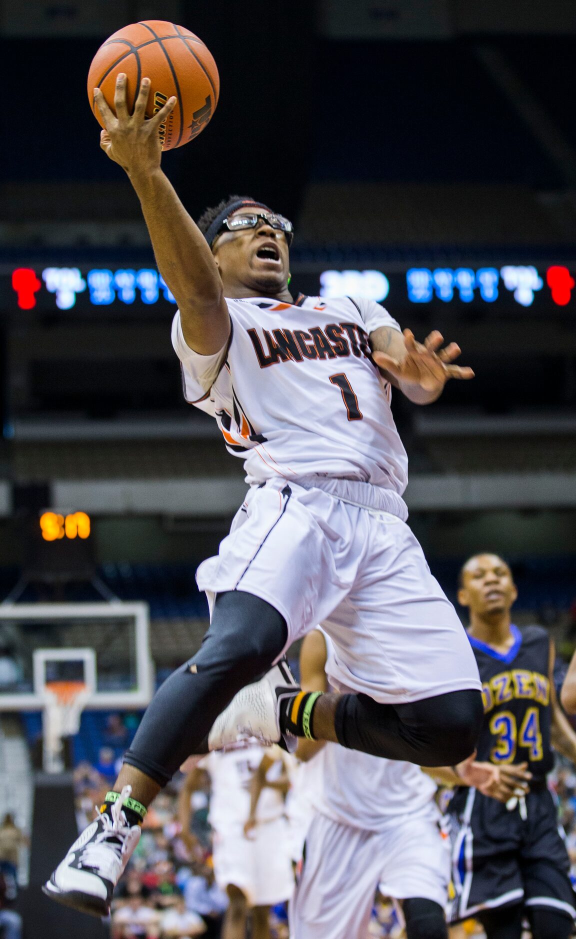 Lancaster guard Dominique Fobbs (1) goes up for a shot against Beaumont Ozen during their...