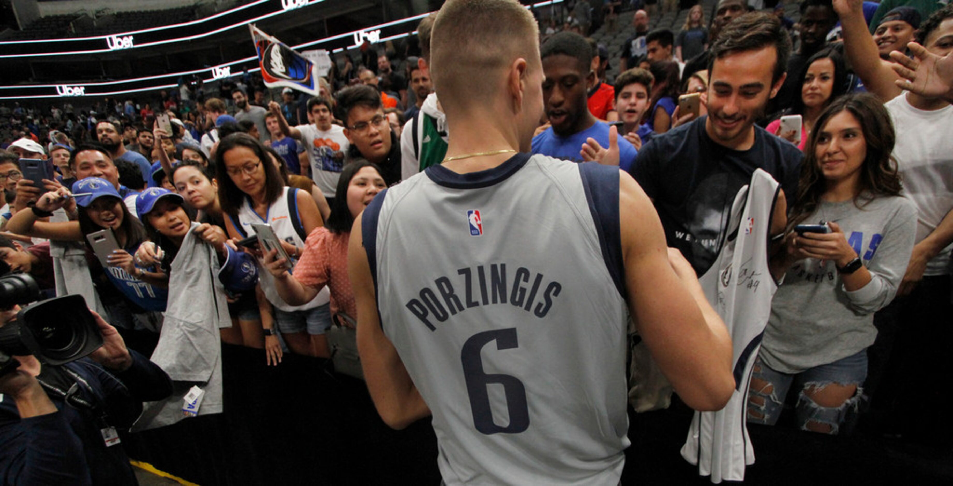 Dallas Mavericks fans crowd at the chance to get a selfie or an autograph on their Mavericks...