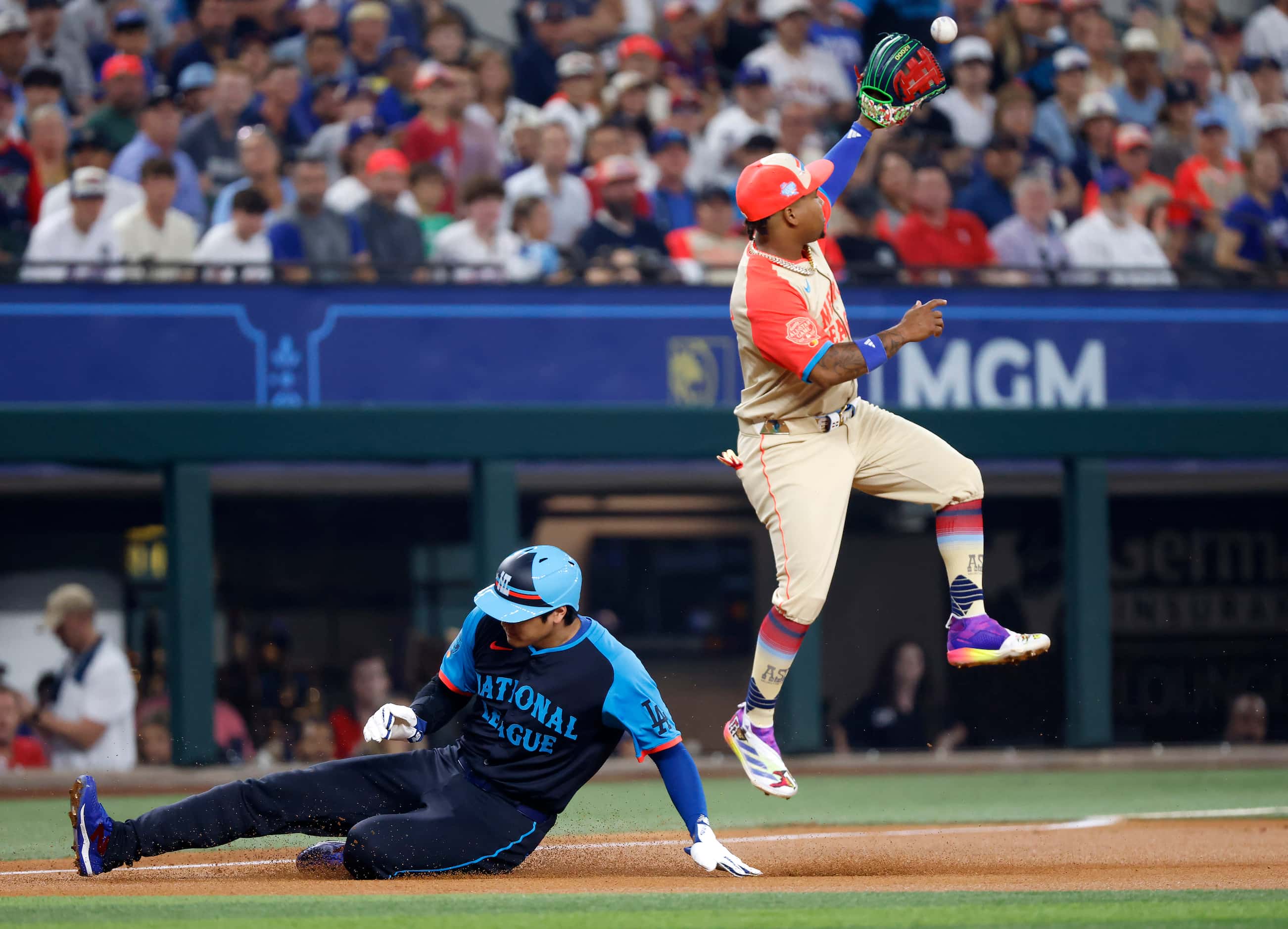 National League's Shohei Ohtani, of the Los Angeles Dodgers, slides safety into third base...