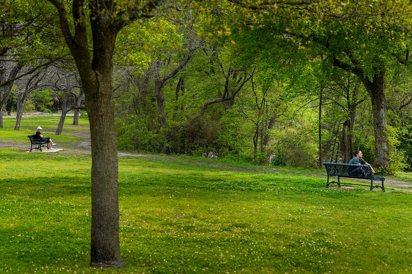 People kept their distance as they sat at separate benches in Prairie Creek Park on March...