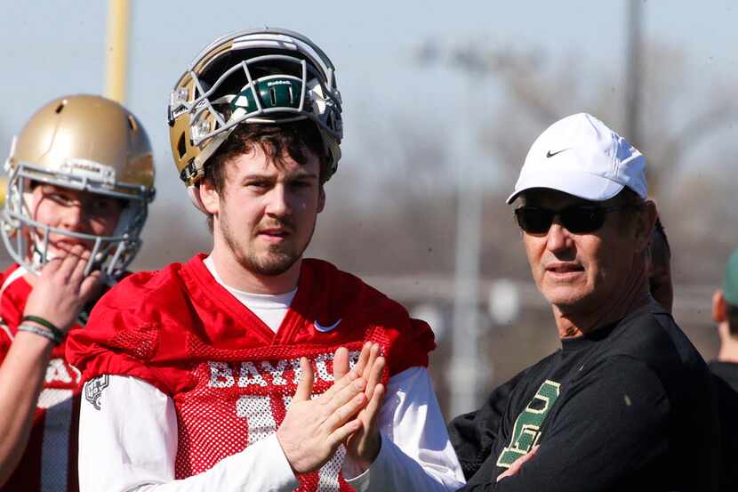 Baylor quarterback Seth Russell looks on with head coach Art Briles during the first day of...