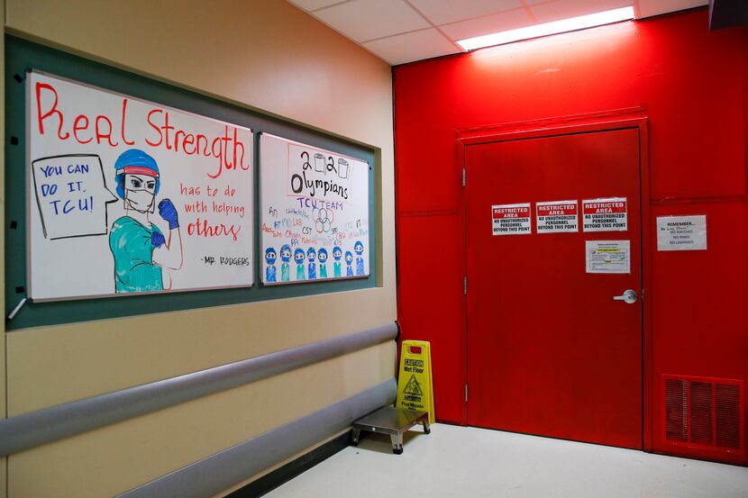 Supportive signs line the wall adjacent to one of the two entrances to Parkland's Tactical...