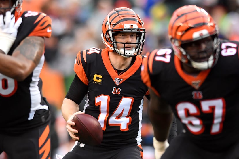 Bengals quarterback Andy Dalton (14) drops back to pass during the first quarter of a game...