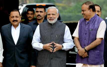 Indian Prime Minister Narendra Modi (C) walks with Bharatiya Janata Party (BJP) leaders as...