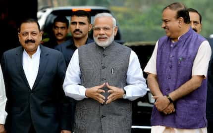 Indian Prime Minister Narendra Modi (C) walks with Bharatiya Janata Party (BJP) leaders as...