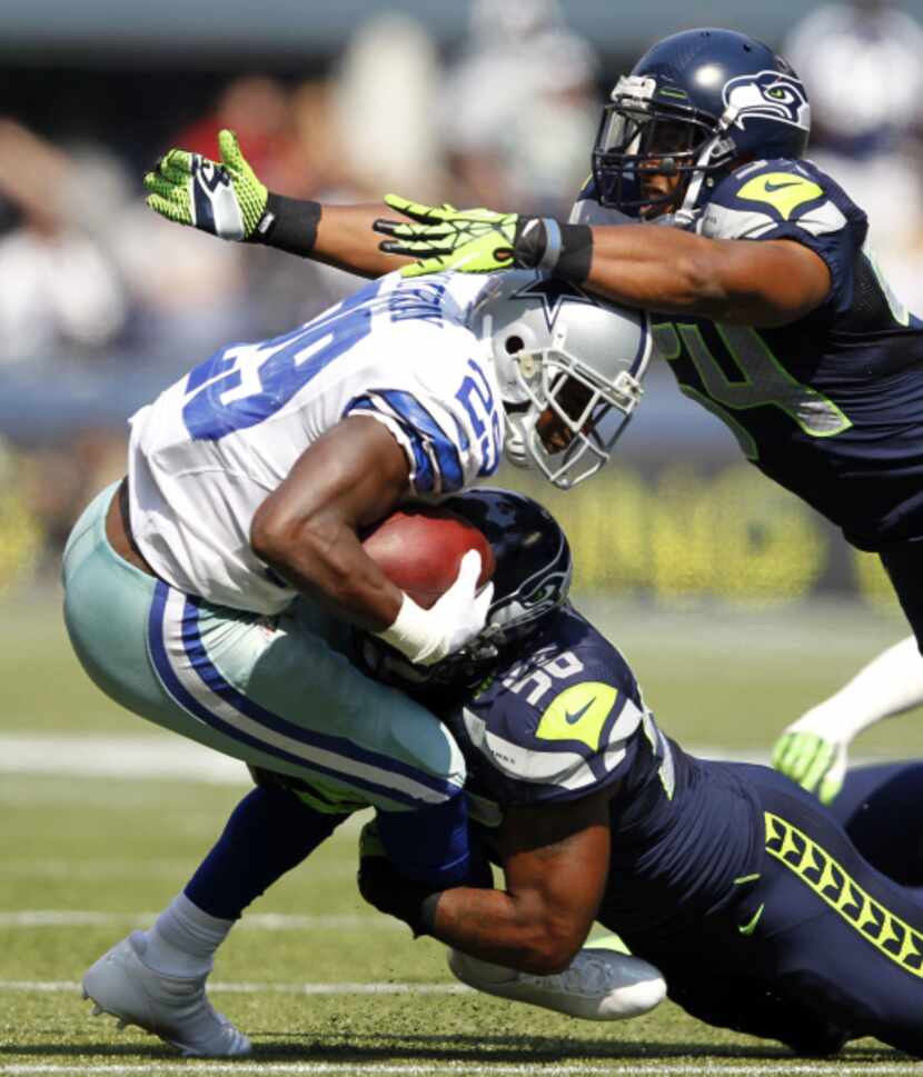 Dallas Cowboys running back DeMarco Murray (29) is brought down by Seattle Seahawks outside...