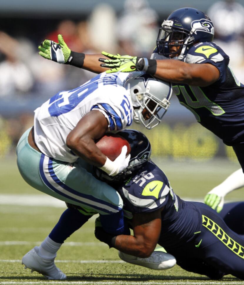 Dallas Cowboys running back DeMarco Murray (29) is brought down by Seattle Seahawks outside...