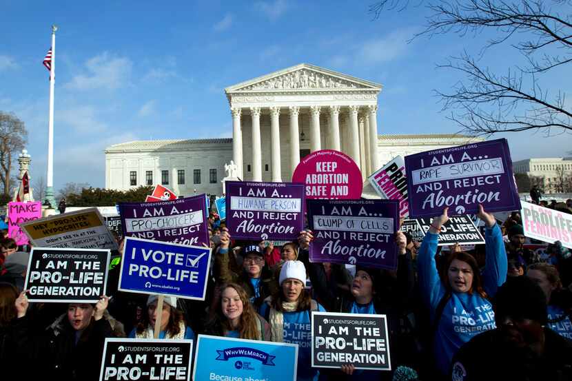 Anti-abortion activists protest outside of the U.S. Supreme Court, during the March for Life...