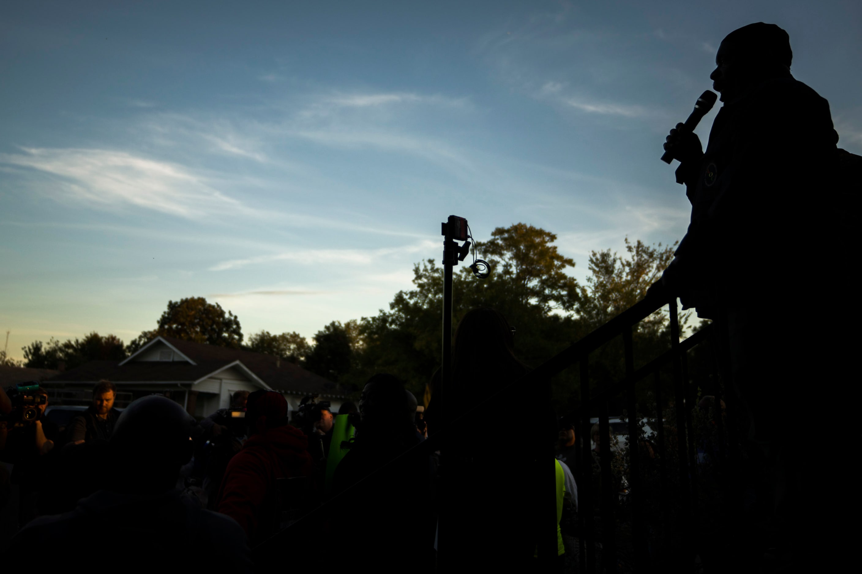 Protestors gather outside the house (right) where Atatiana Jefferson was shot and killed,...