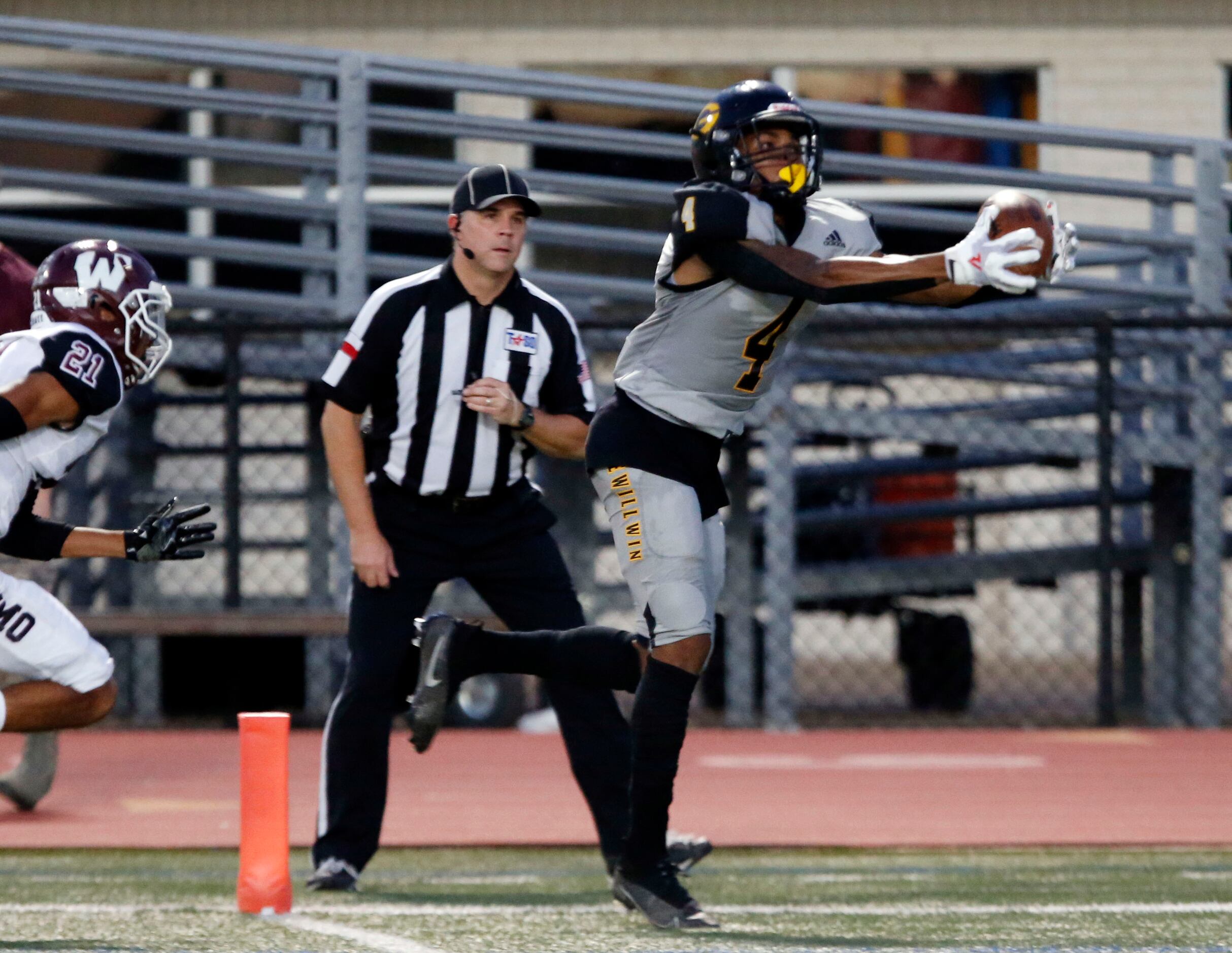 Garland high receiver Charles Allen (4) makes a catch for a touchdown, as Wylie defender...