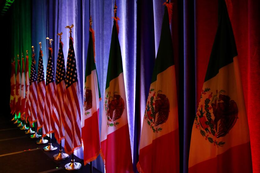 In this Aug. 16, 2017 file photo, the national flags of Canada, the U.S. and Mexico are lit...