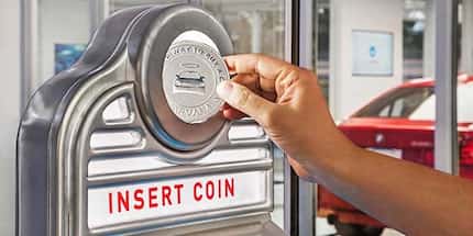 Carvana customers get a giant "coin" to deliver the car they ordered.