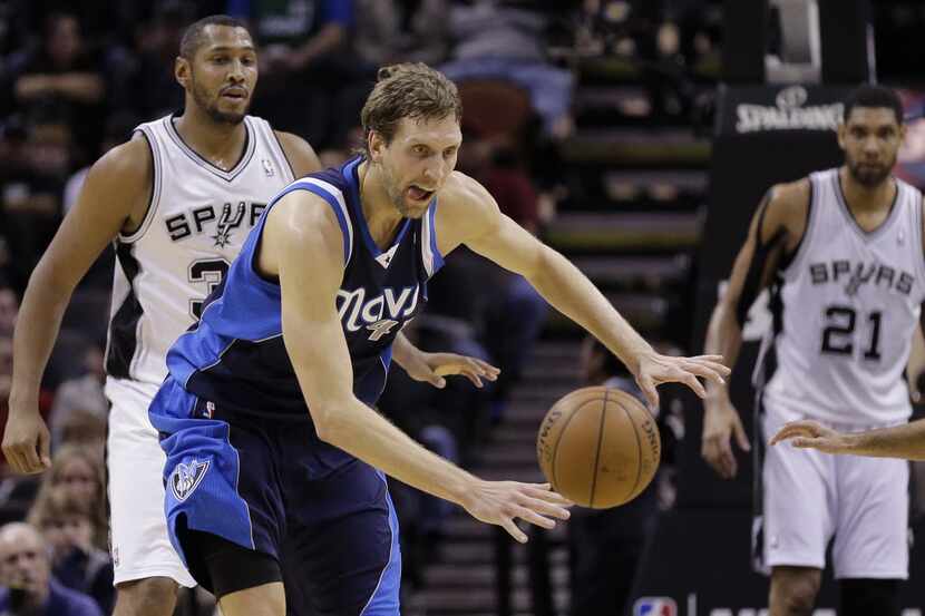 Dallas Mavericks' Dirk Nowitzki chases a loose ball during the first half on an NBA...