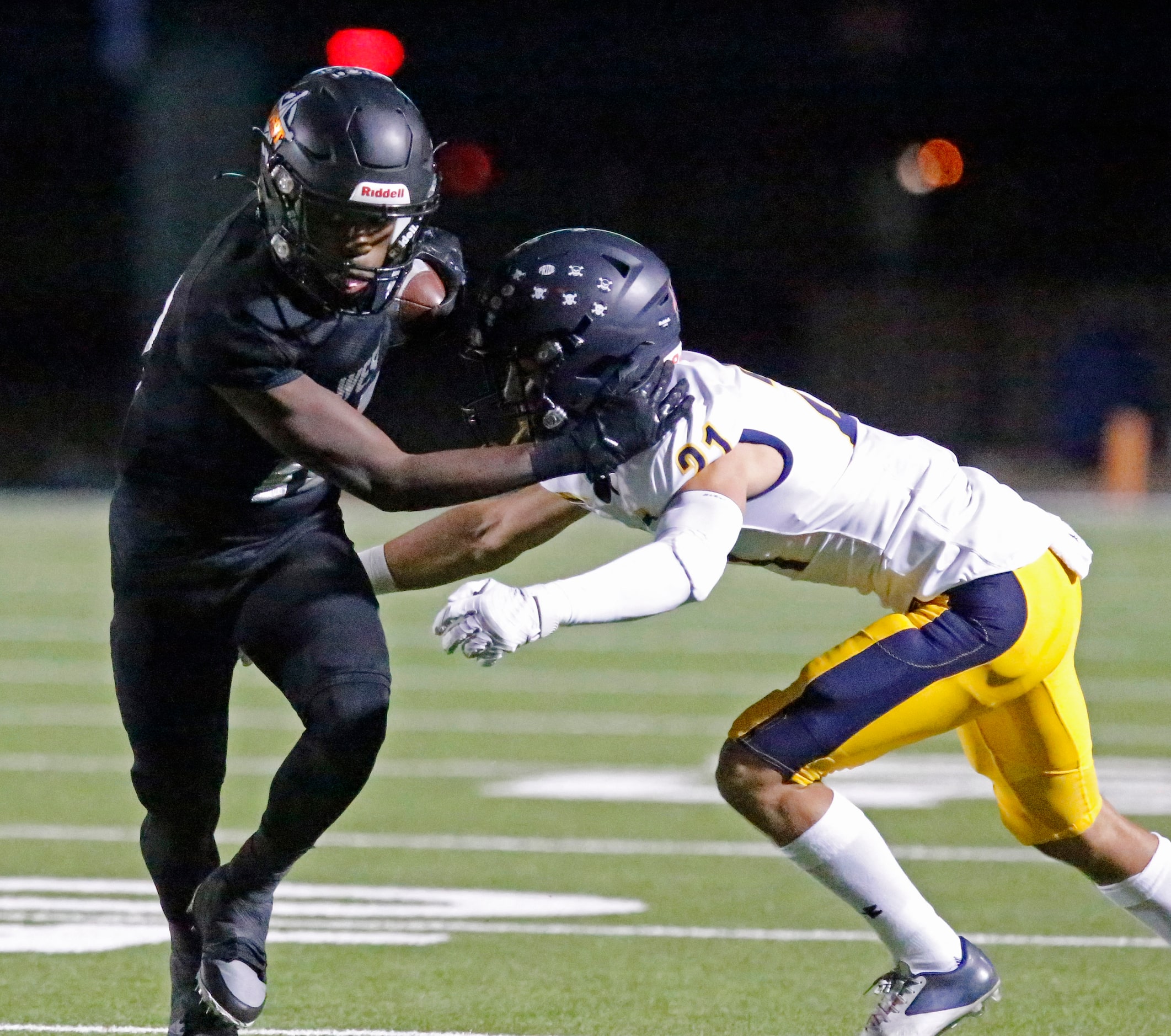 West Mesquite High School wide receiver Javion Jackson (10) stiff arms Highland Park High...