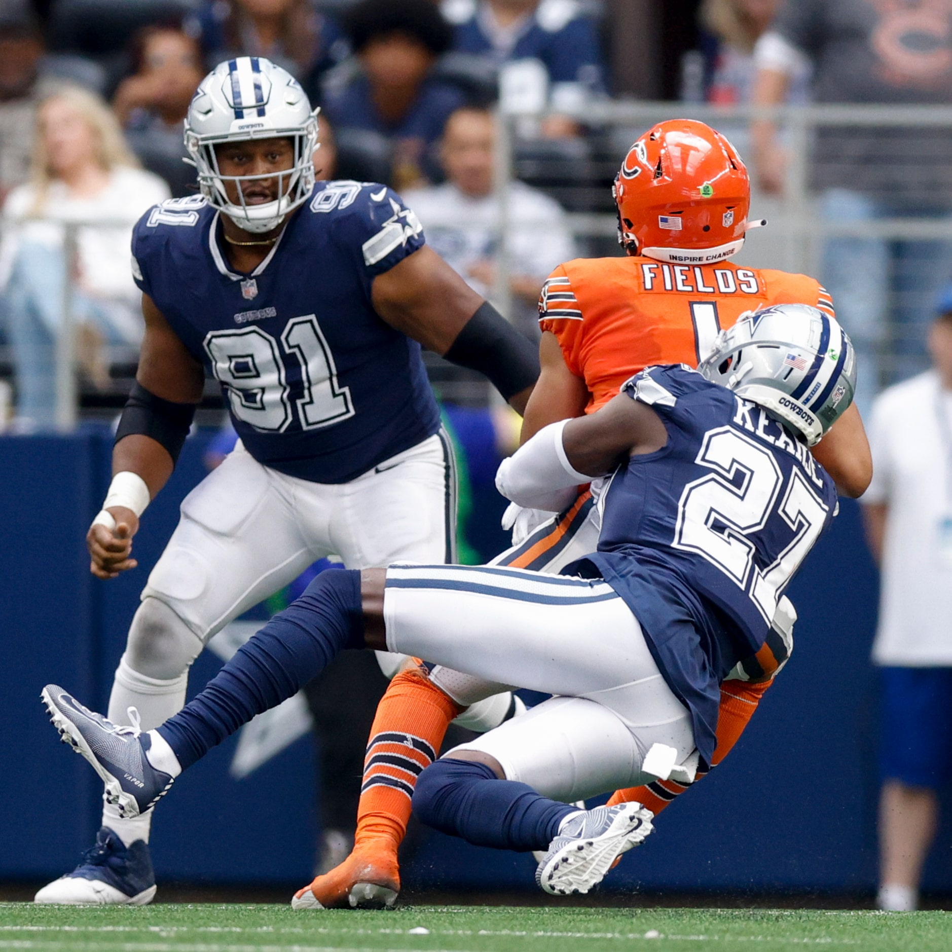 Dallas Cowboys safety Jayron Kearse (27) sacks Chicago Bears quarterback Justin Fields (1)...